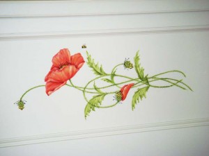 Close-up of hand painted poppies on window seat.