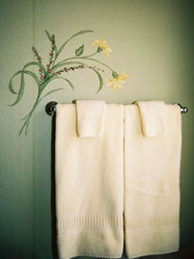 Floral spray of yellow daisies over towel bar
