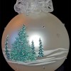 photo of glass ornament with hand painted snow covered pine trees